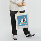 ganeshaのおもちゃのヨットでかわいいペンギンに出会おう Tote Bag