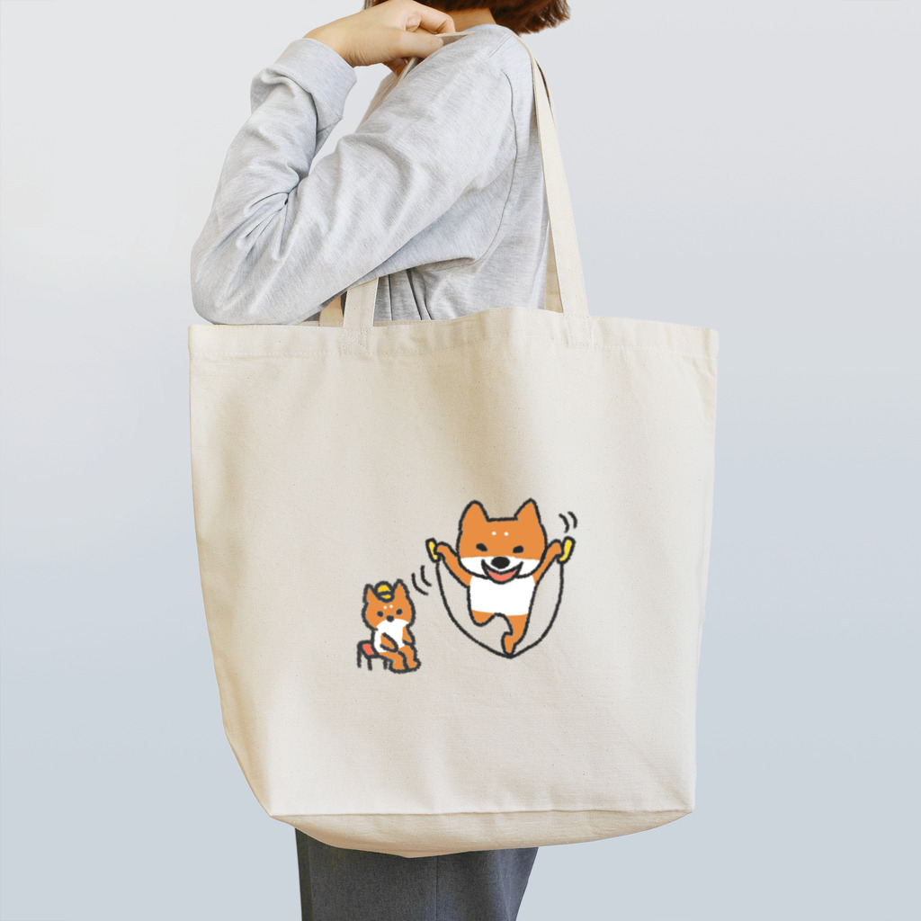 エクレアンショップの縄跳びをする犬と座っている犬 Tote Bag